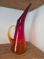Left side view showing amber to red gradient, crackle texture and handle