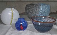 Group of four Kosta Boda glass pieces: Reef bowl, Bon Bon bowl, Rainbow vase, blue bud vase