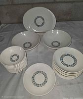 Full set displayed, showing platter, vegetable bowls, stacks of plates and dessert bowls