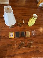 All items grouped: lamp, amber vase, yellow vase, clear vase, frames, easels, wire stand