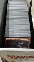 Full stack of cards in storage box, visible card Otherworldly Outburst