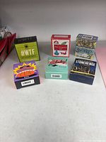 Front view of six boxed novelty and craft kits on tabletop