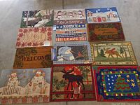 Overall view of 12 visible doormats laid out in rows