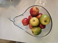 Top view of pear-shaped glass bowl filled with faux apples