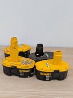 Group of four DeWalt 18V batteries on tabletop