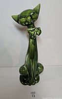 Front view of green drip glaze cat figurine
