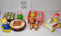 Group shot of figures, furniture, dog, crib, pull toy