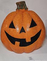 Front view of melted plastic jack-o-lantern