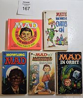 front covers of five MAD books