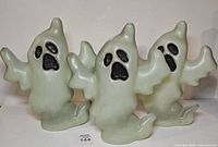 Front view of three translucent ghost toppers