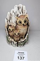 Front view of bisque owl sculpture with number card