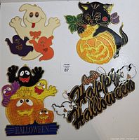All four Halloween plastic window decorations laid out