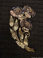 Front view showing floral design and two-tone metals