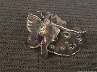 Front view showing butterfly motif and gemstone