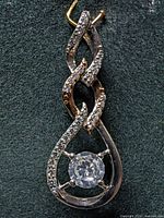 Front view of silver pendant with central CZ and pavé accents