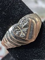 front view heart-shaped silver ring with starburst and ridged shoulders