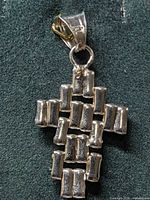 front view of sterling silver cross pendant showing woven bar design and bail