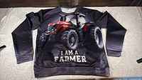 Front view of Monstars sweatshirt laid flat showing full tractor graphic and text