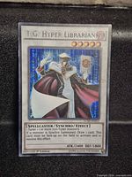 Front of T.G. Hyper Librarian Secret Rare card showing foil, stats and set code