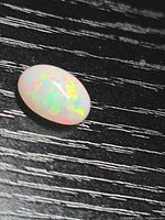 Front view of oval opal showing play of colour