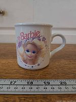 Front view showing Barbie portrait graphic and logo