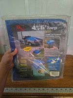 Front of packaged blue poly tarp showing branding and size 4' x 6'