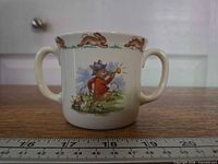 Front view with rabbit boy blowing horn scene and running-rabbit rim border