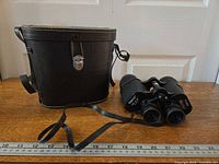Binoculars, case and ruler for scale