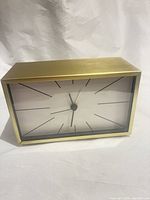 front view showing rectangular gold case and dial