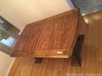 Overall view of wooden dining table showing wood grain and finish from a top angle