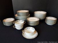 Overall view of the complete set stacked on a black backdrop.