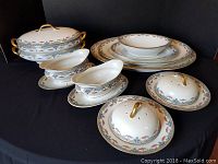 Full view of the set showing covered serving dishes, gravy boats, salt/pepper shakers, platters, and bowl