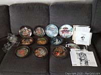 Wide view of all decorative plates arranged on a sofa