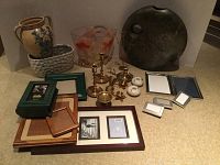 Full lot including pottery vase, textured ceramic vase, glass vase with goldfish, brass candlesticks, white ceramic candle holders, and multiple picture frames.