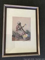 Framed full view of the signed color print featuring a seated woman with flowers and baskets.