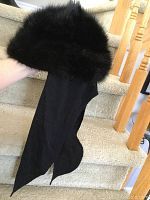 Photo of the black muskrat fur hat showing fur texture and tails.