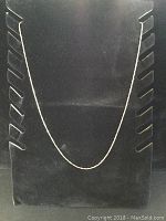 Full view of the 10K gold chain displayed on black velvet stand