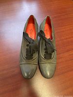Top view of both grey leather oxford heels showing laces and stitching