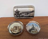 Front view showing all three glass paperweights and images