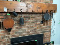 All nine hanging items on mantel above fireplace