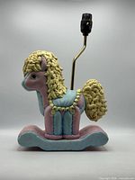 Left profile of ceramic rocking horse lamp without bulb