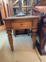 Front view of Ethan Allen end table showing drawer, turned legs and overall condition