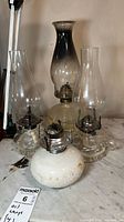 Group shot of all four oil lamps on tabletop