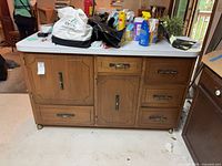 Front view showing drawers, doors, laminate top, hardware, clutter on surface ignored