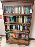 Full view of oak barrister bookcase with books on shelves