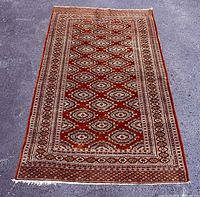 Full view of rug oriented vertically showing pattern and borders
