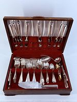 Entire open chest showing full flatware set