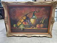 Front view of framed oil painting showing still life subject and ornate gilt frame
