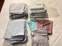 All folded sheets and pillowcases displayed on bed