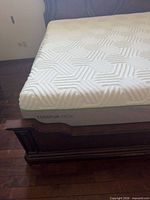 Side corner view of king TEMPUR-Pedic mattress on bed frame